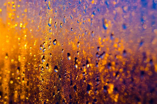 Wet yellow - gold -blue glass background with drops and sparks — Stock Photo, Image