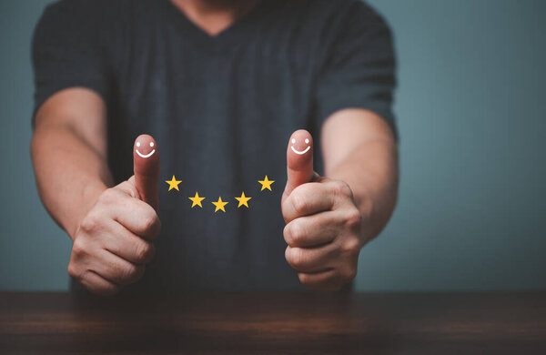 Businessman raised thumps up and give satisfaction five stars rating, sign of the top service, customer good service.