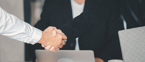Business deal successful of professional business man shaking hands together on the negotiation meeting.