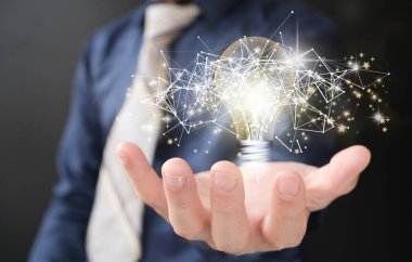close up of businessman holding light bulb icon