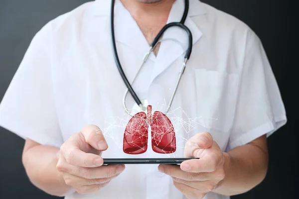 close-up of a male doctor holding a tablet in hands