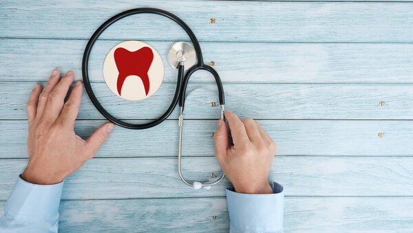 doctor with stethoscope on wooden background