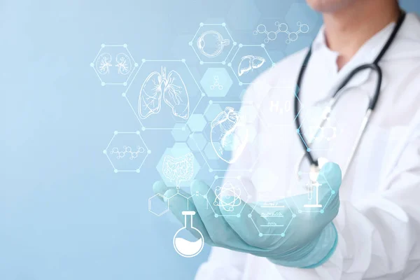 doctor with stethoscope and phone on blue background. medical and healthcare concept.