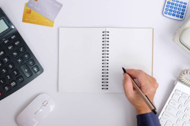 business concept. workplace with notepad, calculator, pen and keyboard on white background.