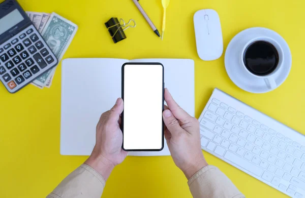 Business Man Holding Smartphone Office Supplies Workplace Yellow Background — 스톡 사진