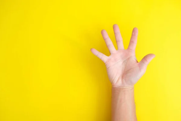 Open Palm Hand Gesture Yellow Background — Photo