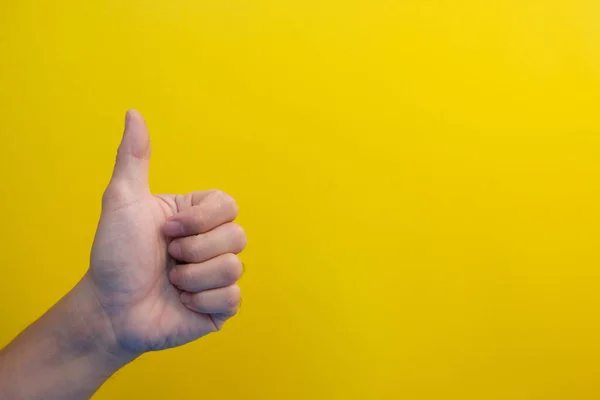 Hand Showing Thumb Sign Yellow Background — 图库照片