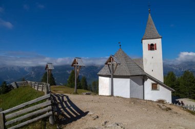 View of the church of Santa Croce under Sass de la Crusc mountain near Badia, Italy.