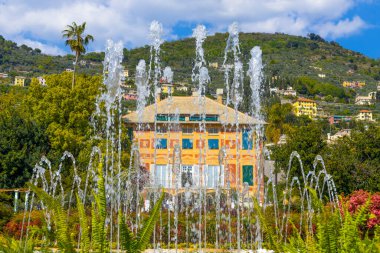 Jets of water from a fountain with Villa Grimaldi on the background in Genoa Nervi Parks, Italy
