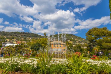 Jets of water from a fountain with Villa Grimaldi on the background in Genoa Nervi Parks, Italy