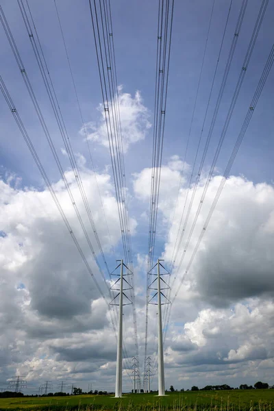 Expansion of the high-voltage grid with many high-voltage pylons to meet the growing demand for electricity, photo taken in the province of Groningen, the Netherlands