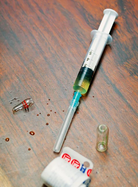Syringe with medicine on wooden table — Stock Photo, Image