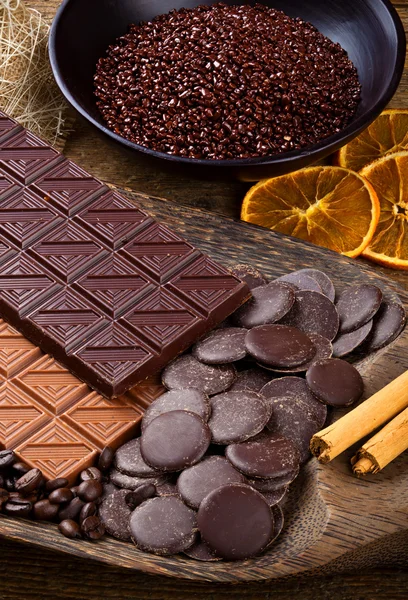 Chocolate com laranja seca fatiada e paus de canela — Fotografia de Stock