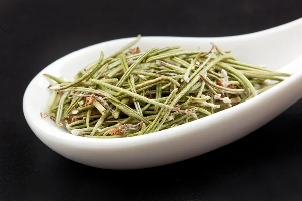Rosemary in white spoon — Stock Photo, Image
