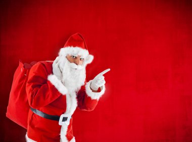 Noel Baba boş kırmızıyı işaret eden çuval ile