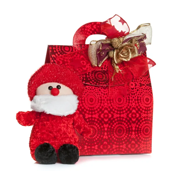 Gift röd väska med santa claus marionett — Stockfoto