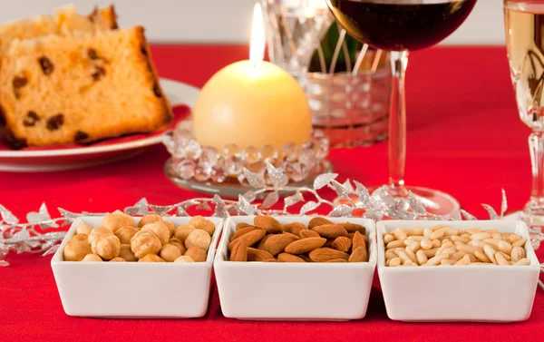 Noix de pin, amandes et noisettes dans des bols sur la table de Noël — Photo