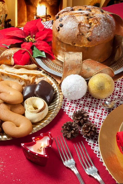 Christmas table near the fireplace — Stock Photo, Image