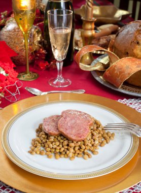 Slices of pig trotter with lentils over christmas table clipart