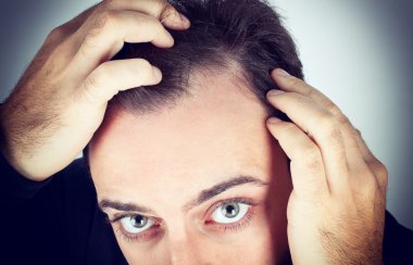 Man controls hair loss clipart