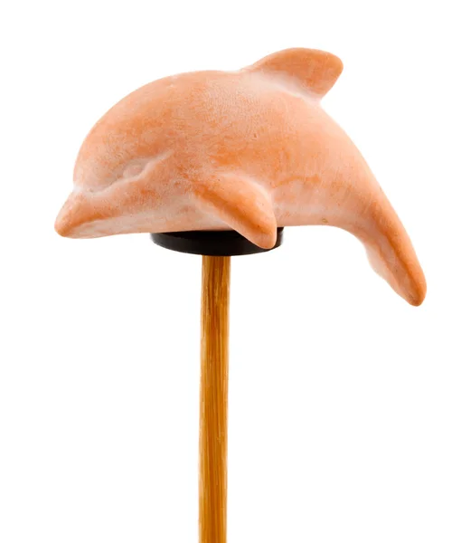 Dolphin in clay on wooden stick — Stock Photo, Image