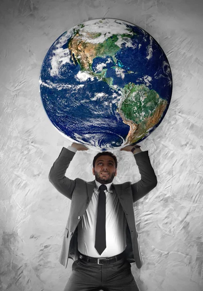 Young businessman sustains the planet Earth — Stock Photo, Image