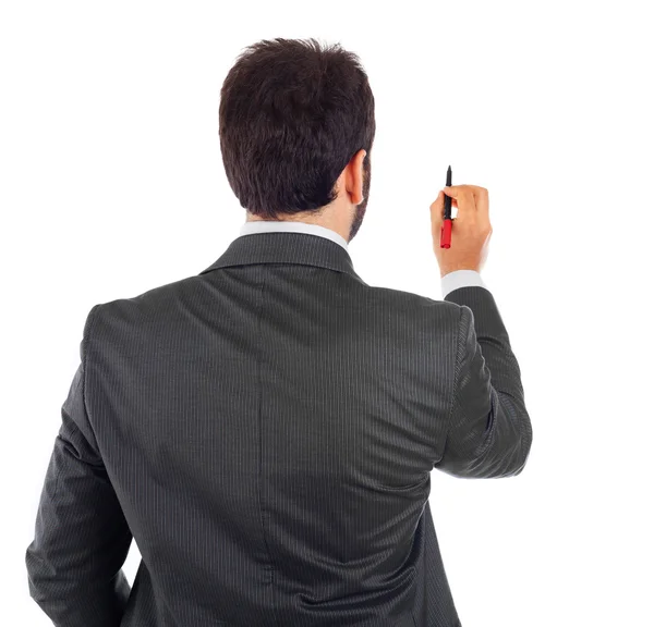 Young businessman turning his back to camera with pen — Stock Photo, Image