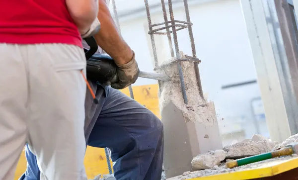 Bryta armerad betong med jackhammer — Stockfoto