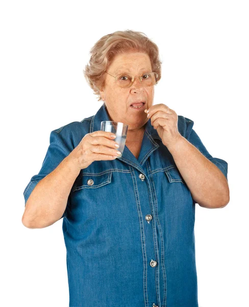 Senior woman taking medicine — Stock Photo, Image