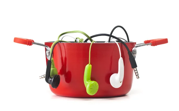 Music headphones in red pot — Stock Photo, Image