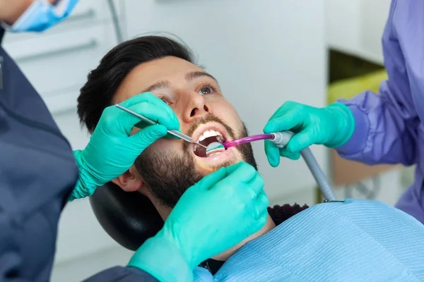 Kadın Dişçi Dişçi Muayenehanesindeki Hastayı Profesyonel Aletler Kişisel Koruyucu Aletlerle — Stok fotoğraf