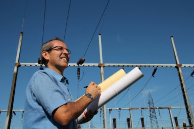 Elektrik Trafo Merkezi yanında mutlu mühendis.