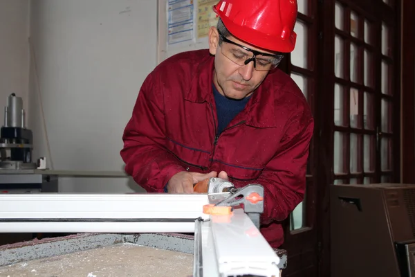 Worker Using Electric Grinder .