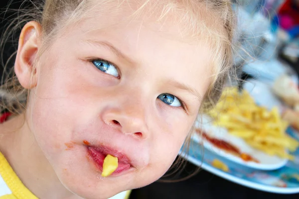 Little girl soiled ketchup french fries — Stock Photo, Image
