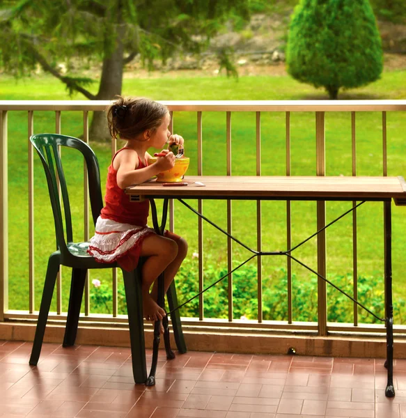 Little girl breakfasting Stock Picture