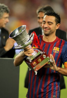 Xavi Hernandez of FC Barcelona holds up Supercup
