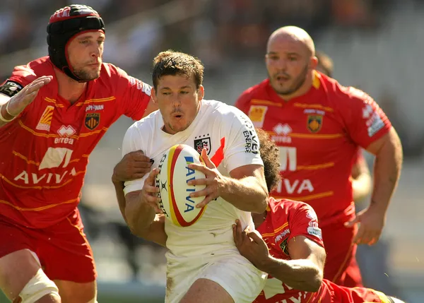 Stade Toulousain Luke Burgess(R) is tackled by USAP player Luke Charteris(L) Stock Picture