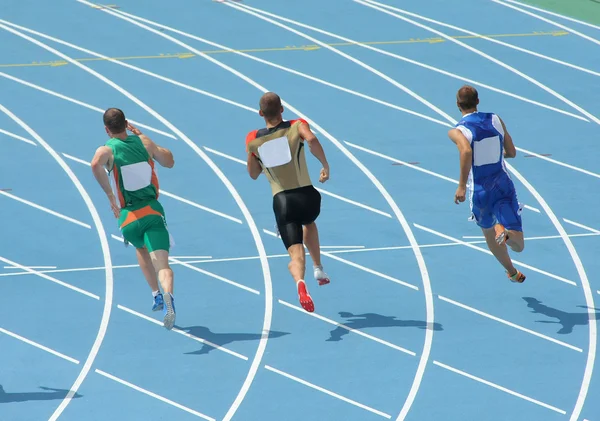 Athletes running on track — Stock Photo, Image