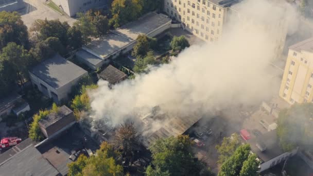 Rescue team with fire truck is working on Extinguishing Fire. Smoke from fire over storage space. — Vídeo de Stock