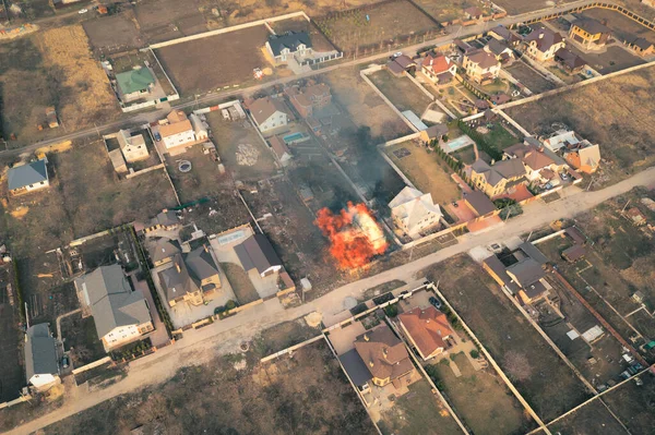 Fire in private house in the middle of private sector - aerial drone view shot. — Stock Photo, Image