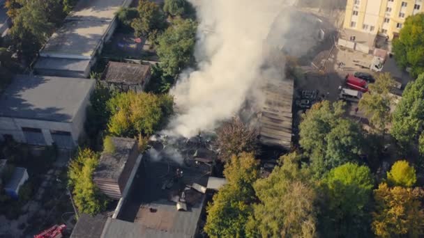 Rescue team with fire truck is working on Extinguishing Fire. Smoke from fire over storage space. — Vídeo de Stock