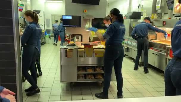 McDonalds team in blue clothes of new design work on the kitchen — Stock Video