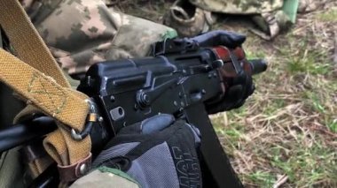 Ukraynalı asker Kalaşnikof otomatik tüfeği cephaneyle doldurdu. Savaşçı ateş etmeden önce Kalaşnikof tüfeğinin kepenğini bozar..
