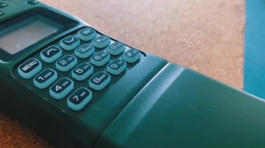 Push-button walkie-talkie on a table with illumination. Walkie-talkie with buttons for radio communication. Backlight of the buttons and the display turns on during using of the radio.
