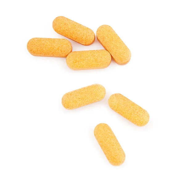 Comprimidos médicos laranja isolado no branco — Fotografia de Stock