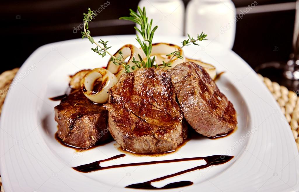 Beef steak with soy sauce, rosemary and onion