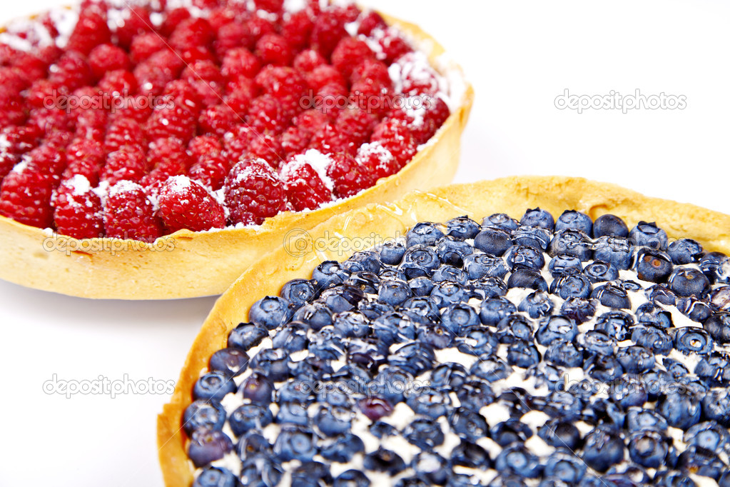 Two pies with blueberries and rasberries