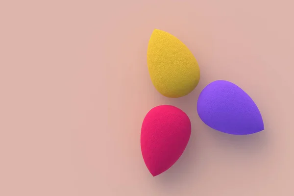 Egg sponges on beige background. Cosmetic accessories. Beauty and fashion. Makeup tools. Top view. Copy space. 3d render