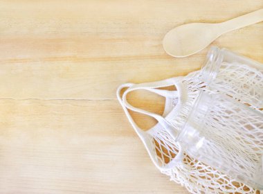 Eco friendly concept, glass jars, shopper and wooden spoon with the selective focus. Good for any project.