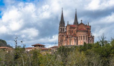Low point view of this great monumental temple built from 1877 to 1901, with a neo-Romanesque style and is made of pinkish marble stone extracted from the mountains of Covadonga